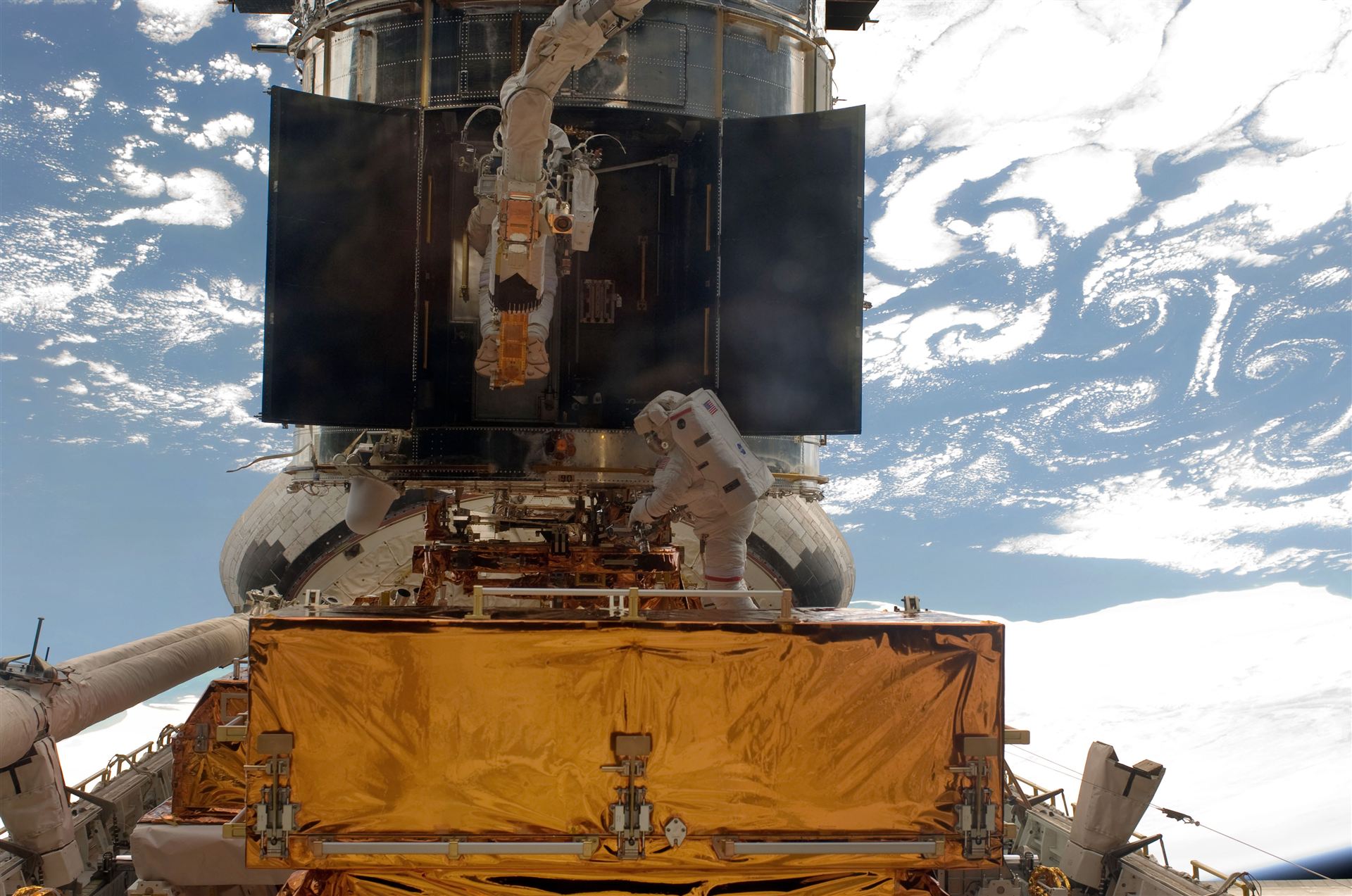 Astronauts at work on Hubble