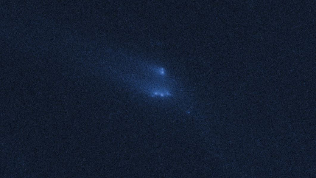 Disintegrating asteroid P2013 R3 as viewed by Hubble on 13 December 2013