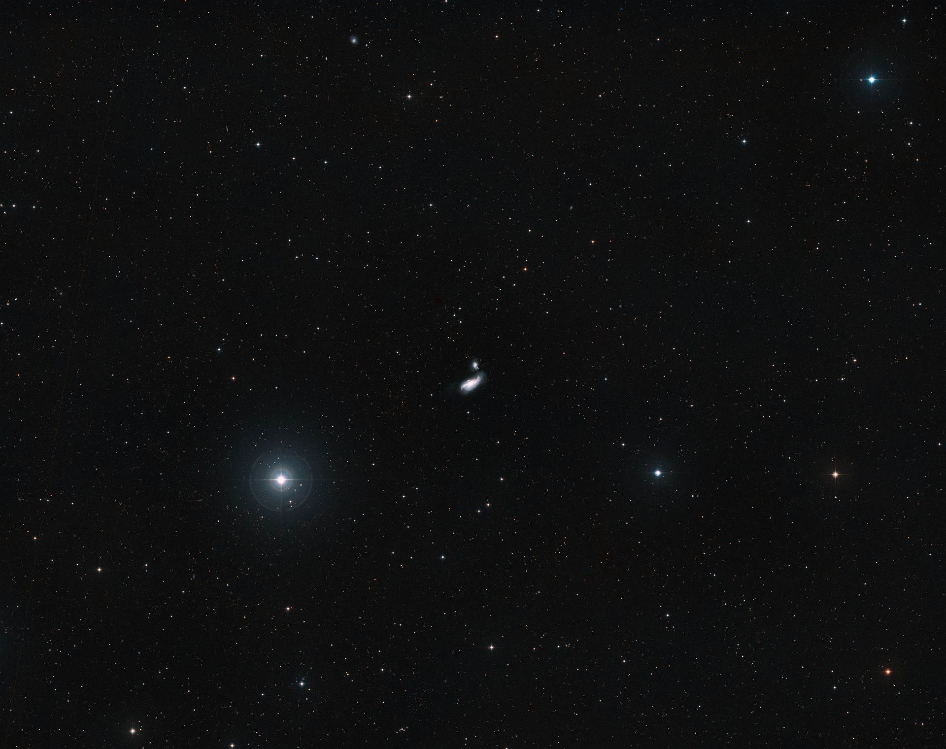 Distant view of a galactic crash — NGC 4490 and NGC 4485 (ground-based image)