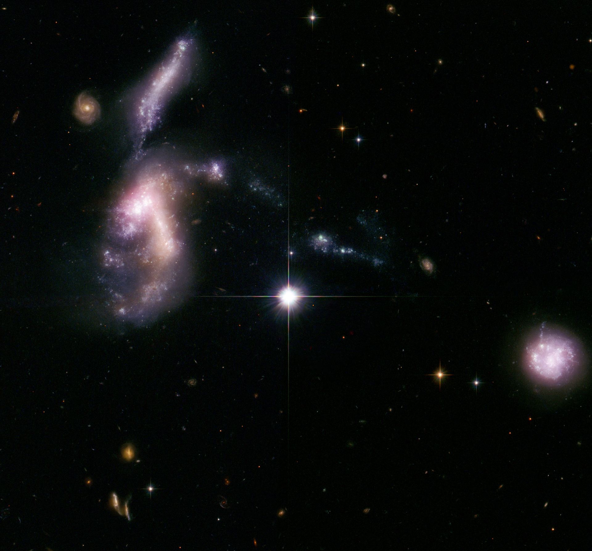 Hickson Compact Group 31 interacting galaxies glow with millions of young stars