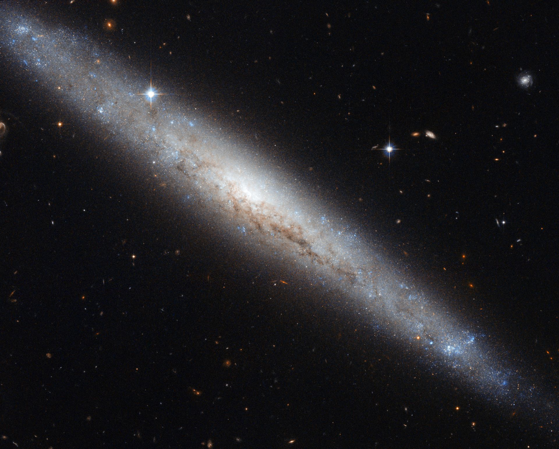 Hubble portrays a dusty spiral galaxy