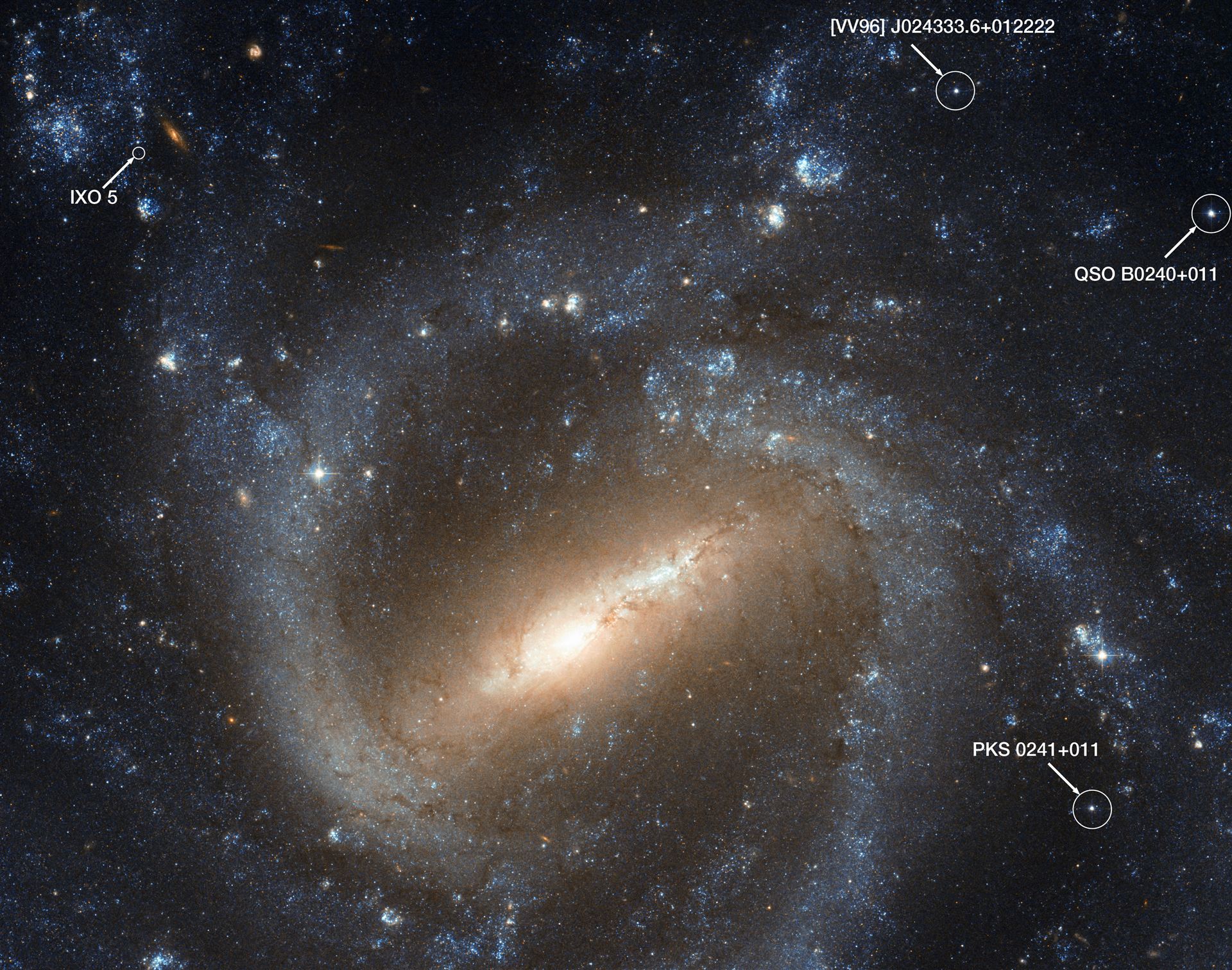 Labelled Hubble image of NGC 1073, showing quasars and IXO 5